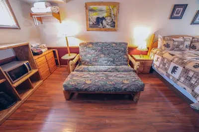 a bedroom with a chair and a bed at Sunnyside Knoll- 1 studio in Estes Park