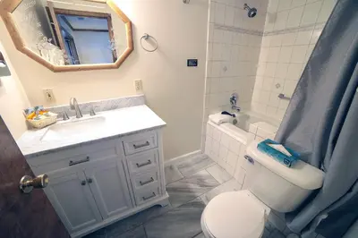 a bathroom with a toilet and a sink and a mirror at Sunnyside Knoll- 1 studio in Estes Park
