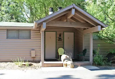 a log cabin with a roof and a porch at Sunnyside Knoll- 1 studio in Estes Park