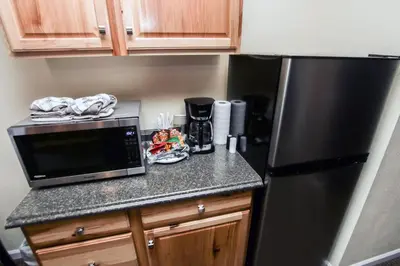 a kitchen with a black refrigerator and a counter top at Fawn Valley Inn- 293 condo in Estes Park