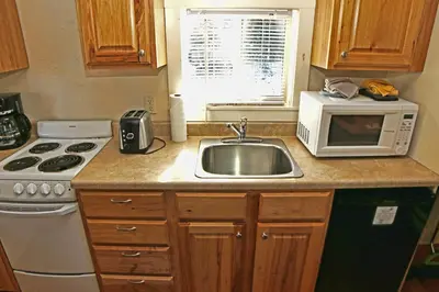 a kitchen with a sink and a microwave at Triple R Cottages- 4 cabin in Estes Park