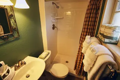 a bathroom with a sink and a toilet and a shower at Triple R Cottages- 4 cabin in Estes Park