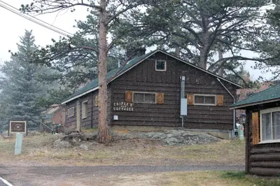 a wooden building with a sign in front of it at Triple R Cottages- 4 cabin in Estes Park