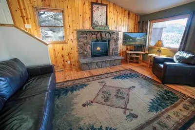 a living room with a couch and a fireplace at Lazy R Cottages- 14 cabin in Estes Park
