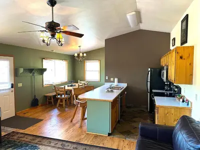 a living room with a kitchen and a dining room at Lazy R Cottages- 14 cabin in Estes Park