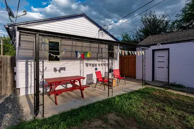 a shed with a picnic table and two chairs at Private Bungalow with Kids Playset in Denver