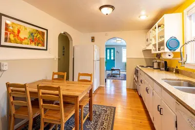 a kitchen with a table and chairs and a refrigerator at Private Bungalow with Kids Playset in Denver