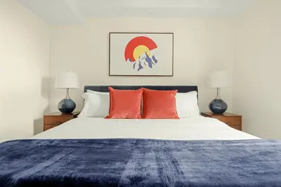 a bedroom with a large bed with red pillows at Heart of Olde Town - Urban Retreat - 95 Walk Score in Arvada