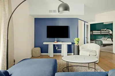 a living room with a blue accent wall at Heart of Olde Town - Urban Retreat - 95 Walk Score in Arvada