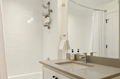 a white bathroom with a sink and a shower at Heart of Olde Town - Urban Retreat - 95 Walk Score in Arvada