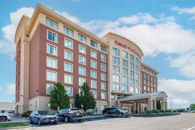 a rendering of a hotel with cars parked in a parking lot at Drury Plaza Hotel Denver Central Park in Denver