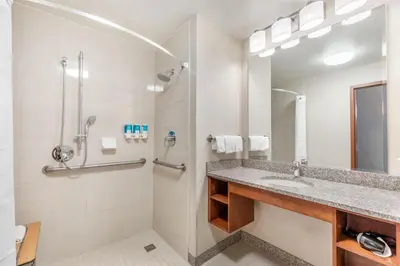 a bathroom with a sink and a shower at Drury Plaza Hotel Denver Central Park in Denver