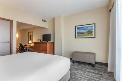 a hotel room with a bed and a desk at Drury Plaza Hotel Denver Central Park in Denver