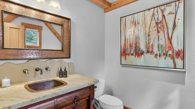 a bathroom with a sink and a mirror at Moose Tracks Lodge in Breckenridge