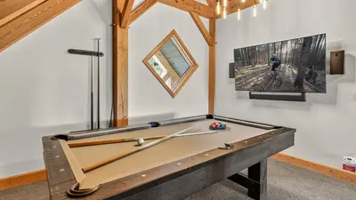 a ping pong table in a room with a pool table at Moose Tracks Lodge in Breckenridge