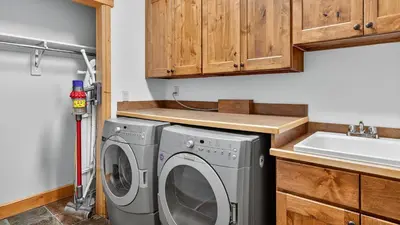 a kitchen with a washing machine and a sink at Moose Tracks Lodge in Breckenridge