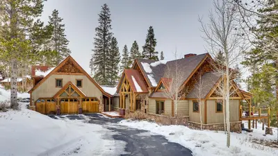 a home in the woods with snow on the ground at Moose Tracks Lodge in Breckenridge