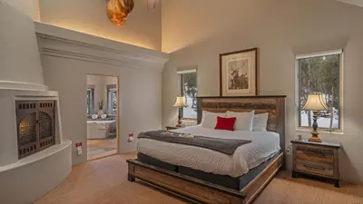 a bedroom with a large bed and a fireplace at Alpenglow Peaks Lodge in Breckenridge