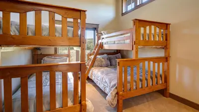 two bunk beds in a room with a staircase at Blue Skies at The Shores in Breckenridge