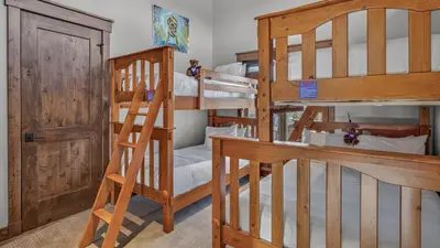 a couple of bunk beds in a room with a ladder at Blue Skies at The Shores in Breckenridge