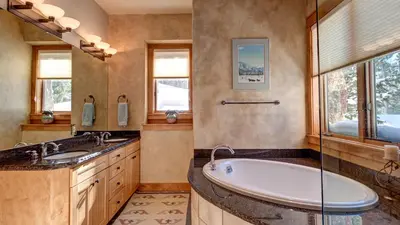 a bathroom with a tub and a sink and windows at Point View Place in Breckenridge
