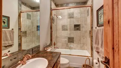 a bathroom with a tub and a sink and a toilet at Point View Place in Breckenridge