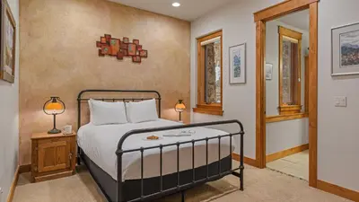 a bedroom with a bed and two lamps on a table at Point View Place in Breckenridge