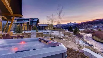 a hot tub in front of a house at River Song at The Shores in Breckenridge