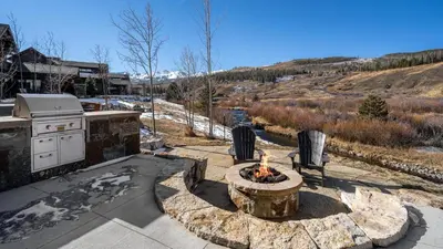 a backyard with a fire pit and a stove at River Song at The Shores in Breckenridge
