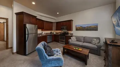 a kitchen with a couch and a refrigerator at Winterfell Estates in Breckenridge