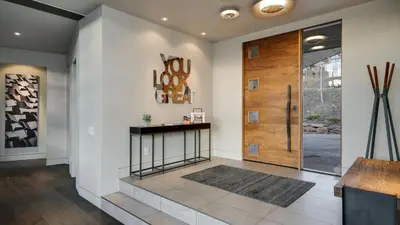 a hallway with a wooden pivot door in a house at Vickerys Vantage in Breckenridge