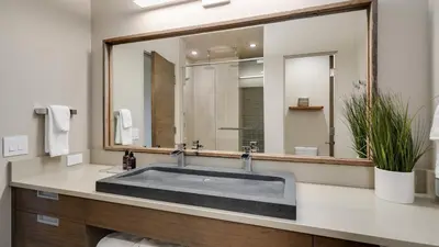 a bathroom with a sink and a large mirror at Vickerys Vantage in Breckenridge