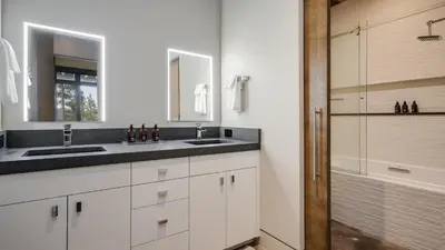 a white bathroom with a sink and a shower at Vickerys Vantage in Breckenridge