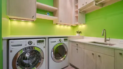 a green kitchen with a washing machine and a sink at Vickerys Vantage in Breckenridge