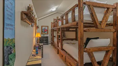 a room with four bunk beds in a house at Cypress Mountain Chalet in Breckenridge