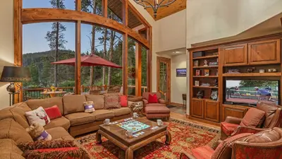 a living room filled with furniture and a large window at Cypress Mountain Chalet in Breckenridge