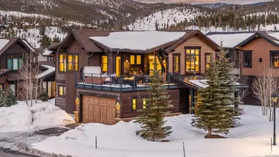 a home in the mountains with snow on the ground at On the Corner at The Shores in Breckenridge