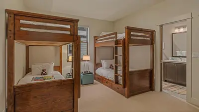 a bedroom with two bunk beds and a mirror at On the Corner at The Shores in Breckenridge