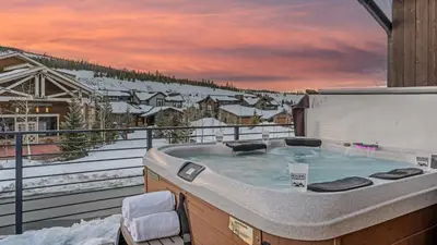 a jacuzzi tub on the balcony of a house at On the Corner at The Shores in Breckenridge