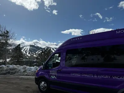 a purple van parked in front of a snowy mountain at On the Corner at The Shores in Breckenridge