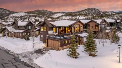 a home in the mountains with snow on the ground at On the Corner at The Shores in Breckenridge