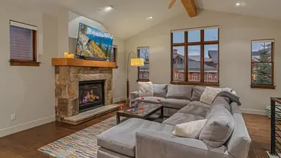 a living room with a couch and a fireplace at On the Corner at The Shores in Breckenridge