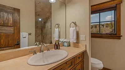 a bathroom with a sink and a toilet and a mirror at Monte Video in Breckenridge