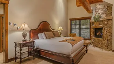 a bedroom with a large bed and a fireplace at Monte Video in Breckenridge
