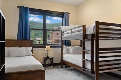 two bunk beds in a room with a window at 4BD Family Friendly Minutes from River Run Gondola in Keystone