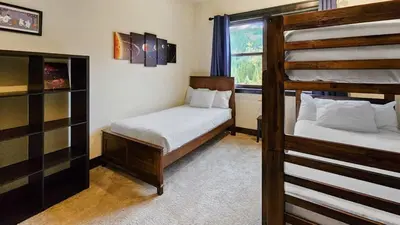 a bedroom with two bunk beds and a window at 4BD Family Friendly Minutes from River Run Gondola in Keystone