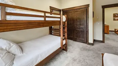 two bunk beds in a room with a closet at 4BD Family Friendly Minutes from River Run Gondola in Keystone