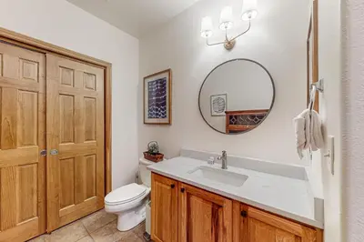 a bathroom with a sink and a toilet and a mirror at Blue River Grove in Silverthorne