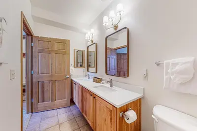 a bathroom with a sink and a toilet and a mirror at Blue River Grove in Silverthorne