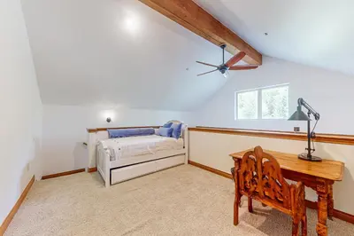 a bedroom with a bed and a desk and a table at Blue River Grove in Silverthorne
